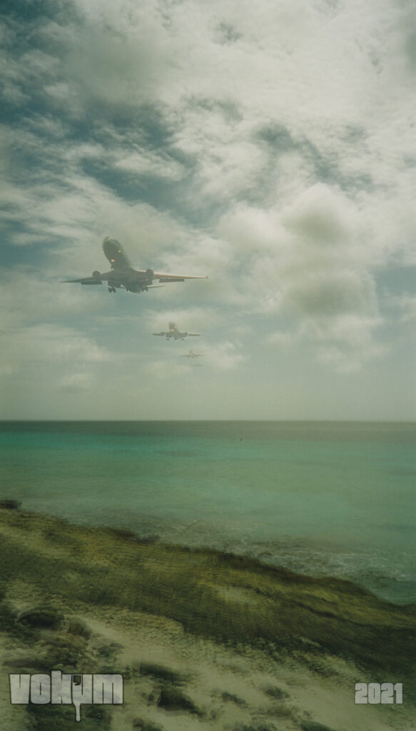 Airplane is approaching. 4 stages in 1 layered photo. Bit of a beach is visible on the foreground.