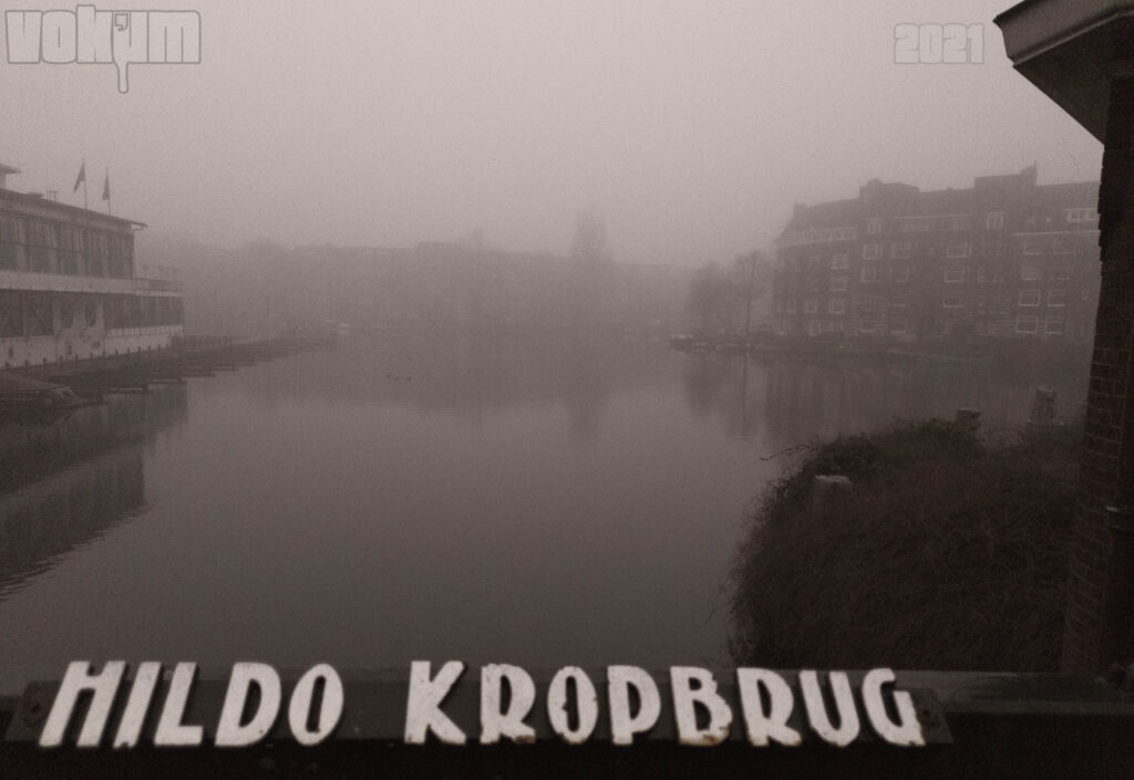 Misty Amsterdam (zuid). The name of the Hildo Kropbrug and an overview of De Kom. Apollo Hotel Amsterdam partly in view.